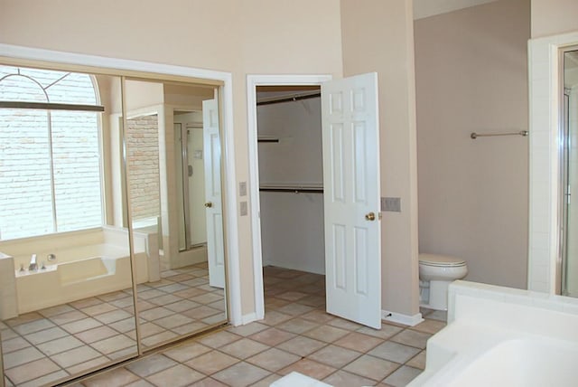 2118 Linea Del Pino St, Houston, TX 77077 - bathroom featuring healthy amount of natural light, a stall shower, a bath, and a spacious closet
