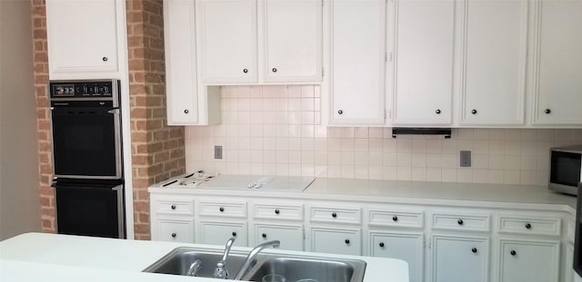 2118 Linea Del Pino St, Houston, TX 77077 - kitchen with a sink, stainless steel microwave, light countertops, tasteful backsplash, and white cabinetry