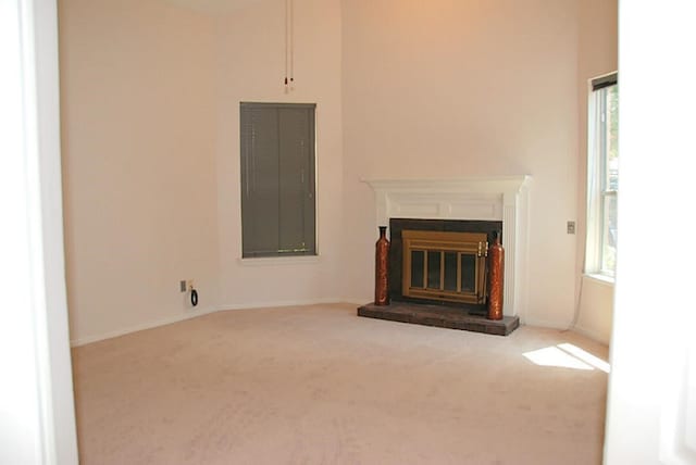 2118 Linea Del Pino St, Houston, TX 77077 - unfurnished living room featuring carpet floors, a glass covered fireplace, and baseboards