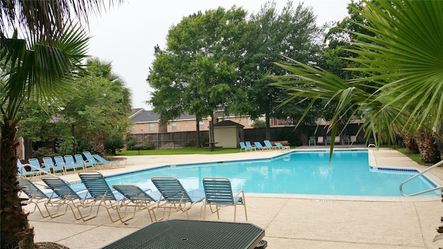 2118 Linea Del Pino St, Houston, TX 77077 - community pool featuring a storage shed, fence, a patio area, and an outdoor structure
