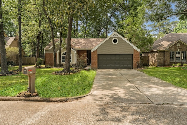 125 Park Way, Conroe, TX 77356 - view of front of house with an attached garage, driveway, and brick siding