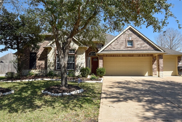 2603 Briar Rose Ct, Pearland, TX 77584 - view of front facade featuring an attached garage, driveway, stone siding, and brick siding