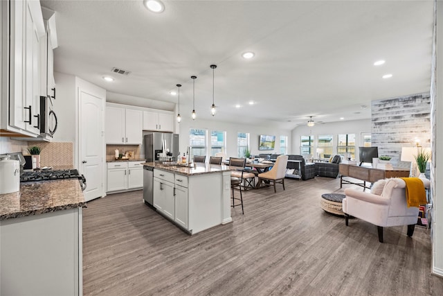 208 Catalina Cove Dr, Katy, TX 77493 - kitchen with stainless steel appliances, recessed lighting, open floor plan, a kitchen breakfast bar, and a sink