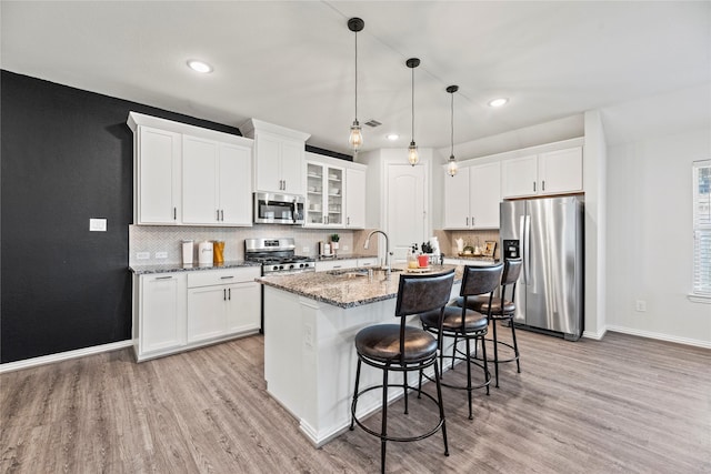 208 Catalina Cove Dr, Katy, TX 77493 - kitchen with appliances with stainless steel finishes, a sink, light wood-type flooring, baseboards, and recessed lighting