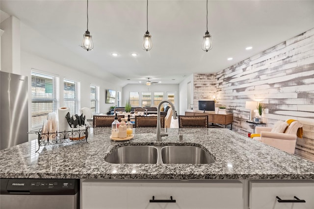 208 Catalina Cove Dr, Katy, TX 77493 - kitchen with open floor plan, a sink, dishwasher, dark stone countertops, and recessed lighting