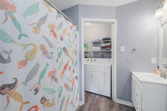 424 Angel Wing St, Surfside Beach, TX 77541 - full bathroom featuring washer / clothes dryer, wood finished floors, a textured wall, vanity, and baseboards