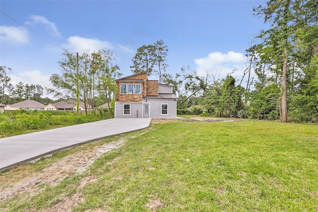 18586 Summer Hills Blvd, Porter, TX 77365 - rear view of property featuring a lawn, metal roof, driveway, and a standing seam roof