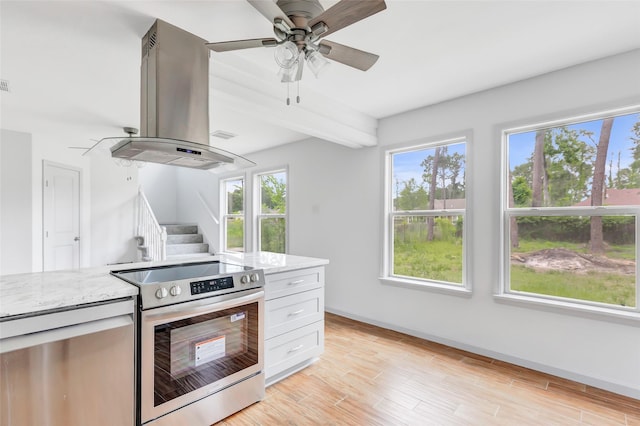18586 Summer Hills Blvd, Porter, TX 77365 - kitchen with electric range, island range hood, light stone countertops, beam ceiling, and baseboards