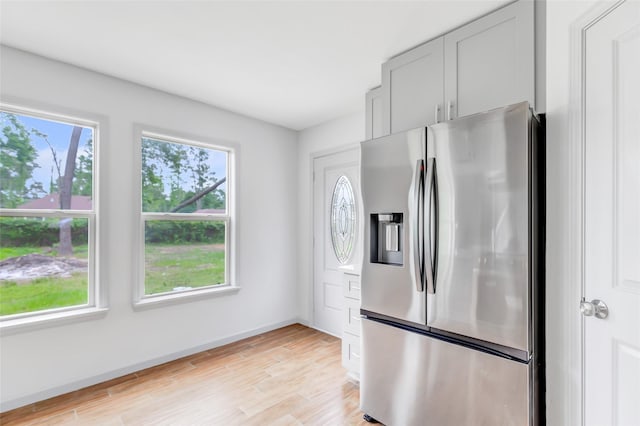 18586 Summer Hills Blvd, Porter, TX 77365 - kitchen with stainless steel fridge with ice dispenser, light wood finished floors, baseboards, and gray cabinetry