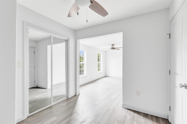 18586 Summer Hills Blvd, Porter, TX 77365 - unfurnished room featuring a ceiling fan, light wood finished floors, and baseboards