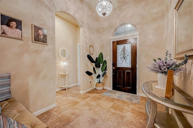 182 Climbing Oaks Pl, Montgomery, TX 77316 - foyer entrance with arched walkways, baseboards, and a chandelier