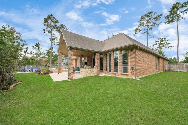18910 Winding Atwood Ln, Tomball, TX 77377 - rear view of house with brick siding, a patio area, a shingled roof, and exterior kitchen