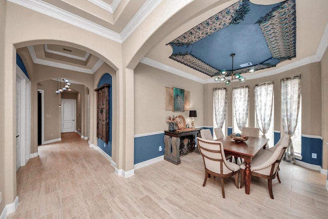 18910 Winding Atwood Ln, Tomball, TX 77377 - dining room with a chandelier, arched walkways, a raised ceiling, baseboards, and ornamental molding