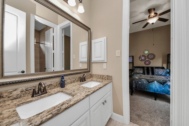 18910 Winding Atwood Ln, Tomball, TX 77377 - ensuite bathroom with double vanity, a ceiling fan, and baseboards