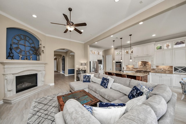 18910 Winding Atwood Ln, Tomball, TX 77377 - living area with arched walkways, a ceiling fan, recessed lighting, baseboards, and light wood finished floors