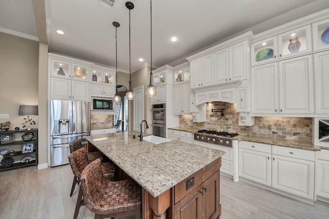 18910 Winding Atwood Ln, Tomball, TX 77377 - kitchen featuring stainless steel appliances, a sink, an island with sink, recessed lighting, and backsplash