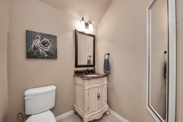 18910 Winding Atwood Ln, Tomball, TX 77377 - bathroom featuring toilet, vaulted ceiling, vanity, and baseboards