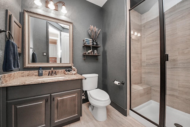 18910 Winding Atwood Ln, Tomball, TX 77377 - full bath with a shower stall, a textured wall, toilet, and vanity