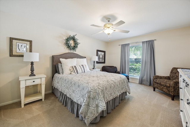 7575 Katy Fwy Unit 17, Houston, TX 77024 - bedroom featuring light carpet, a ceiling fan, and baseboards