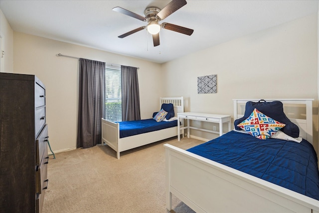 7575 Katy Fwy Unit 17, Houston, TX 77024 - bedroom featuring light colored carpet, ceiling fan, and baseboards