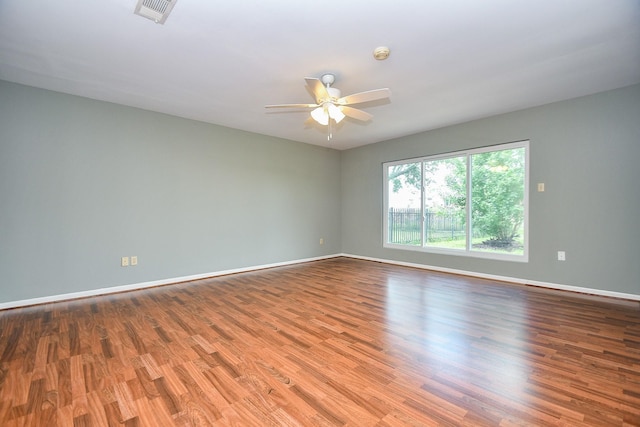 2808 Cypress Point Dr, Missouri City, TX 77459 - unfurnished room with a ceiling fan, baseboards, wood finished floors, and a smoke detector