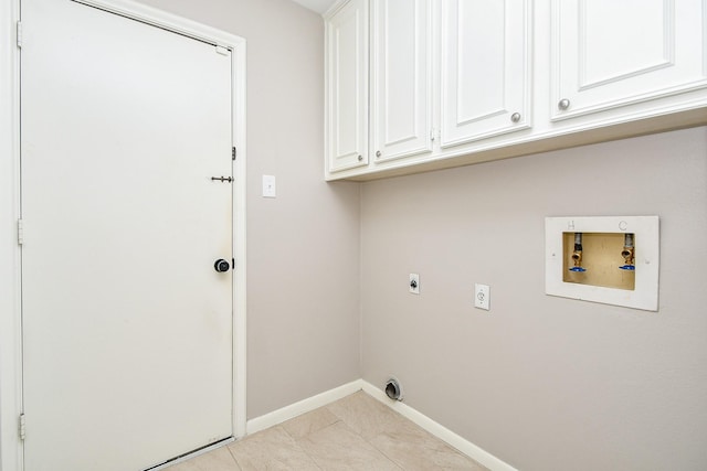 2808 Cypress Point Dr, Missouri City, TX 77459 - clothes washing area with electric dryer hookup, cabinet space, hookup for a washing machine, baseboards, and light tile patterned floors