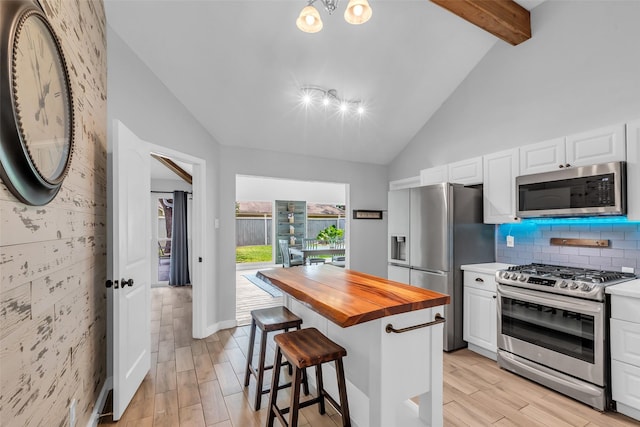 9802 Pale Star Dr, Houston, TX 77064 - kitchen with appliances with stainless steel finishes, wood counters, white cabinetry, and wood tiled floors