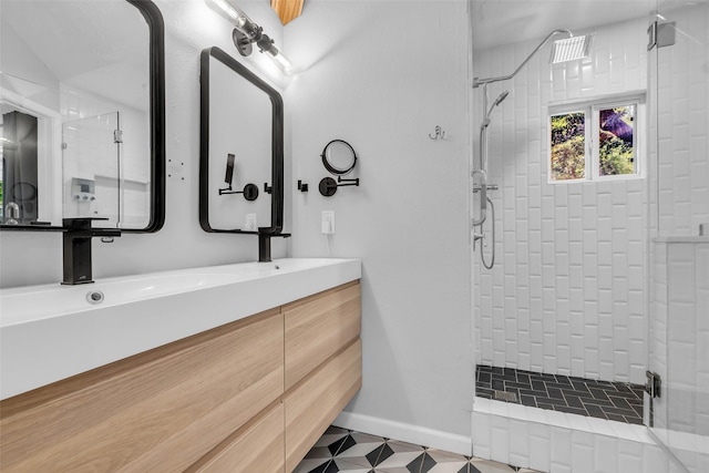 9802 Pale Star Dr, Houston, TX 77064 - full bath with a shower stall, double vanity, and baseboards