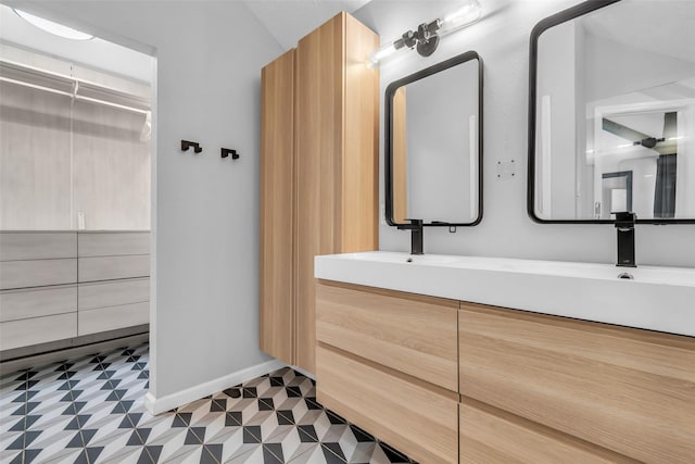 9802 Pale Star Dr, Houston, TX 77064 - full bathroom featuring double vanity, tile patterned floors, and baseboards