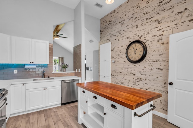 9802 Pale Star Dr, Houston, TX 77064 - kitchen with stainless steel appliances, butcher block counters, an accent wall, a sink, and a ceiling fan