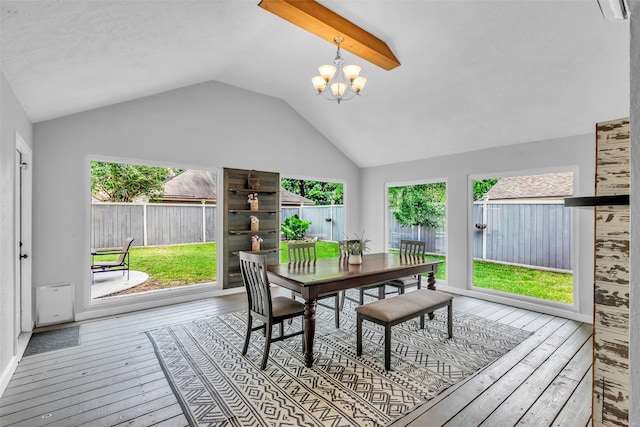 9802 Pale Star Dr, Houston, TX 77064 - dining space with hardwood / wood-style flooring, lofted ceiling, healthy amount of natural light, and a chandelier