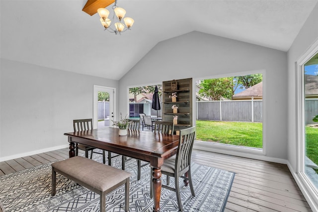 9802 Pale Star Dr, Houston, TX 77064 - dining room featuring a chandelier, hardwood / wood-style flooring, vaulted ceiling, plenty of natural light, and baseboards