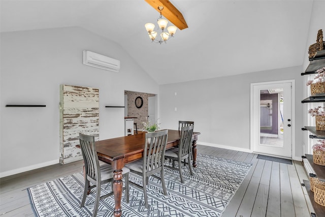 9802 Pale Star Dr, Houston, TX 77064 - dining room featuring an AC wall unit, lofted ceiling, wood-type flooring, a chandelier, and baseboards