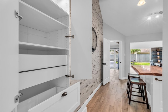 9802 Pale Star Dr, Houston, TX 77064 - bathroom with vaulted ceiling, wood finished floors, and baseboards