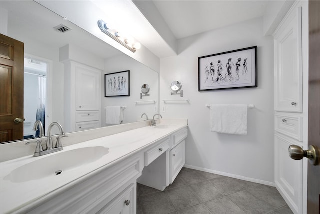 12806 Ivyforest Dr, Cypress, TX 77429 - full bathroom featuring tile patterned floors, double vanity, and baseboards