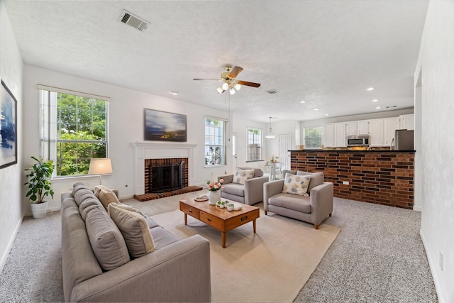815 Spring Valley Ct, Sugar Land, TX 77479 - living area featuring plenty of natural light, ceiling fan, a brick fireplace, light colored carpet, and recessed lighting