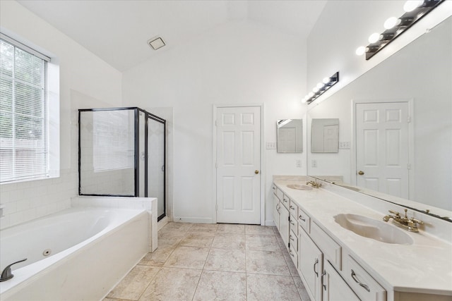815 Spring Valley Ct, Sugar Land, TX 77479 - bathroom featuring a jetted tub, double vanity, a stall shower, high vaulted ceiling, and baseboards