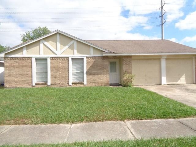 8115 Swan Meadow Ln, Humble, TX 77338 - view of front of home featuring a garage, driveway, brick siding, and a front lawn
