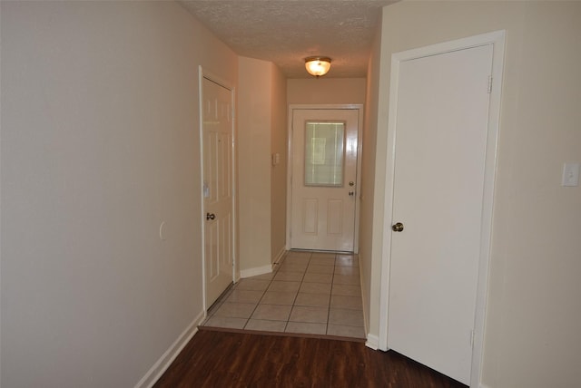 8115 Swan Meadow Ln, Humble, TX 77338 - corridor featuring a textured ceiling, baseboards, and tile patterned floors