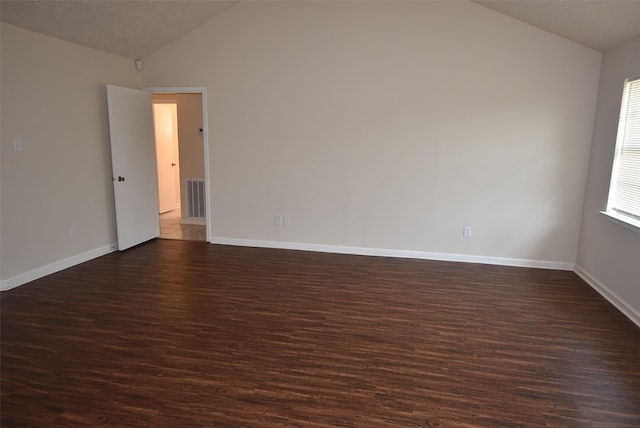 8115 Swan Meadow Ln, Humble, TX 77338 - spare room featuring lofted ceiling, dark wood-type flooring, and baseboards