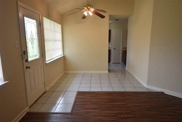 8115 Swan Meadow Ln, Humble, TX 77338 - foyer with light tile patterned floors, a ceiling fan, baseboards, and lofted ceiling