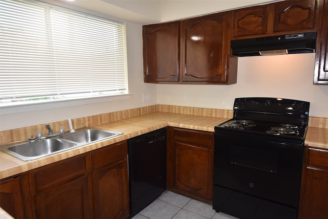 8115 Swan Meadow Ln, Humble, TX 77338 - kitchen with black appliances, under cabinet range hood, a sink, and light countertops