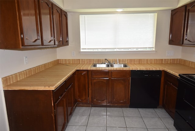 8115 Swan Meadow Ln, Humble, TX 77338 - kitchen featuring black appliances, a sink, light tile patterned floors, and light countertops