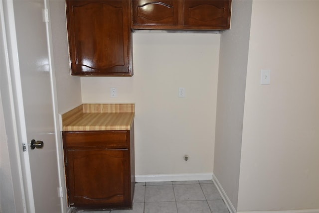8115 Swan Meadow Ln, Humble, TX 77338 - kitchen featuring light countertops, light tile patterned floors, and baseboards