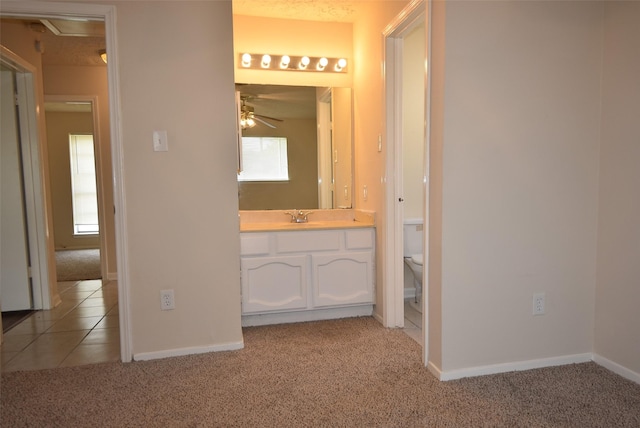 8115 Swan Meadow Ln, Humble, TX 77338 - bathroom with a ceiling fan, carpet, toilet, vanity, and baseboards