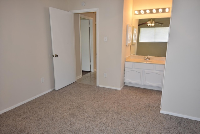8115 Swan Meadow Ln, Humble, TX 77338 - unfurnished bedroom featuring light carpet, a sink, baseboards, and connected bathroom
