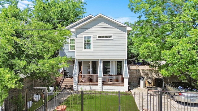 2719 Alabama St, Houston, TX 77004 - view of front facade with covered porch, a fenced front yard, and a gate