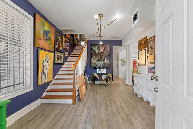 2719 Alabama St, Houston, TX 77004 - foyer featuring wood finished floors, stairway, and baseboards
