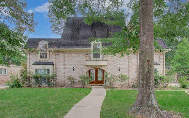 10523 Fawnview Dr, Houston, TX 77070 - view of front of property featuring french doors, a front yard, a shingled roof, and brick siding