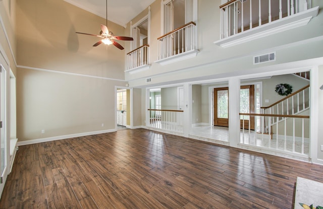 10523 Fawnview Dr, Houston, TX 77070 - unfurnished living room with a high ceiling, a ceiling fan, wood finished floors, baseboards, and stairway